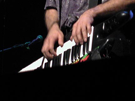 Closeup of Eric playing keyboards